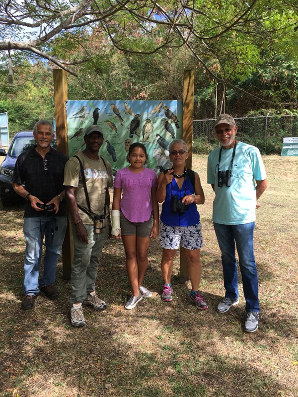 Anthony Jeremiah - 2nd from left - and Grenadian bird lovers are bird watching at Mount Hartman.